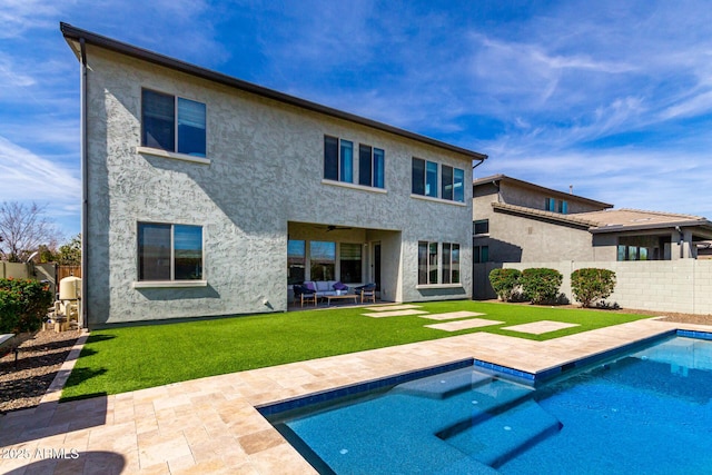 rear view of property with a yard, a fenced backyard, an outdoor hangout area, and a patio