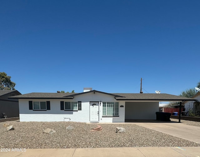 ranch-style home with a carport