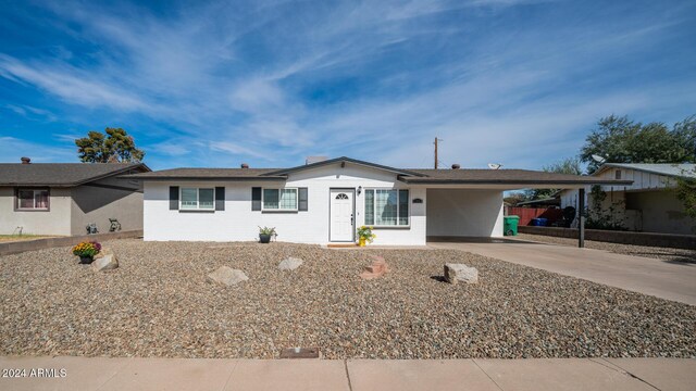 ranch-style home with a carport