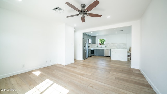 unfurnished living room featuring ceiling fan and light hardwood / wood-style floors