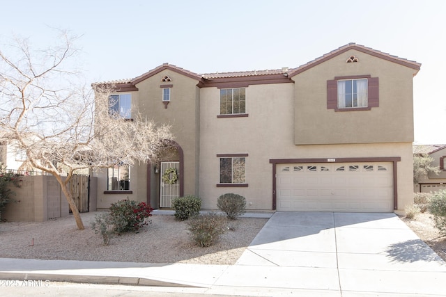 mediterranean / spanish-style house with driveway, a tile roof, fence, and stucco siding