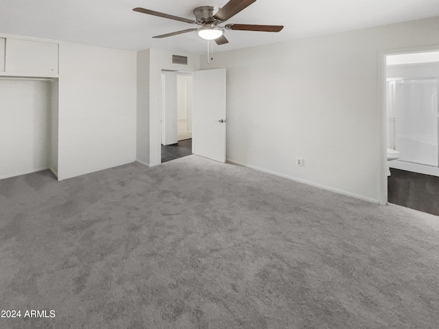 unfurnished bedroom with ensuite bathroom, visible vents, carpet flooring, and a ceiling fan