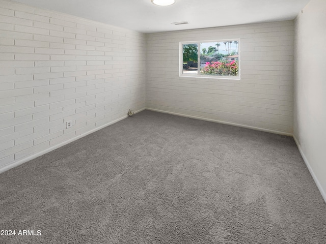 empty room with brick wall and carpet