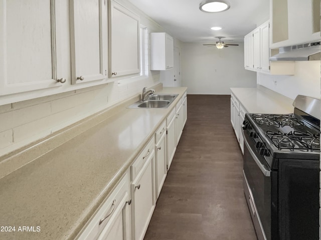 kitchen featuring stainless steel range with gas cooktop, a sink, tasteful backsplash, dark wood-style flooring, and light countertops