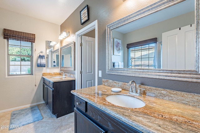 13318 W Indianola Ave, Litchfield Park, AZ 85340 - bathroom featuring two vanities, tile patterned floors, a textured wall, and baseboards