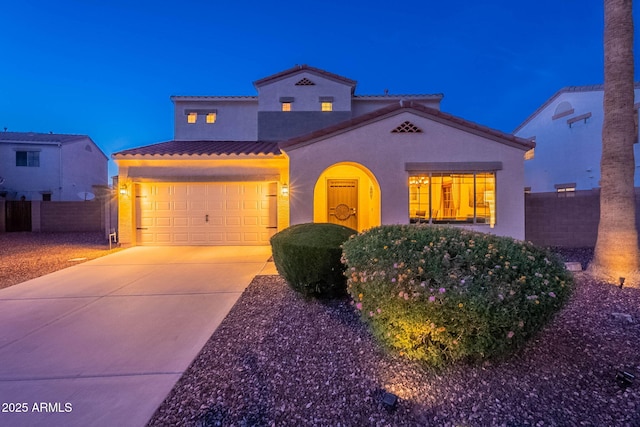13318 W Indianola Ave, Litchfield Park, AZ 85340 - mediterranean / spanish house featuring a tiled roof, stucco siding, concrete driveway, and a garage
