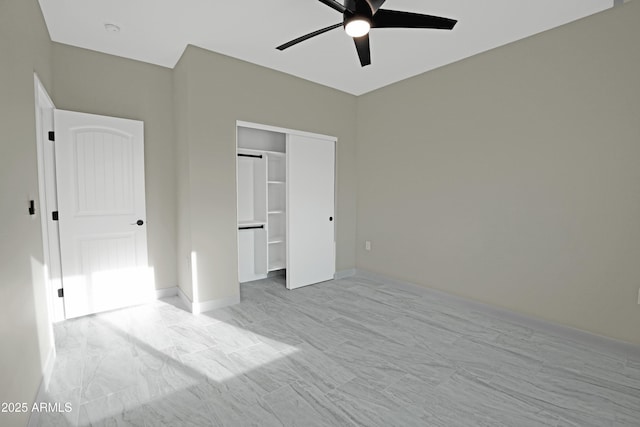 unfurnished bedroom featuring a ceiling fan, a closet, and baseboards