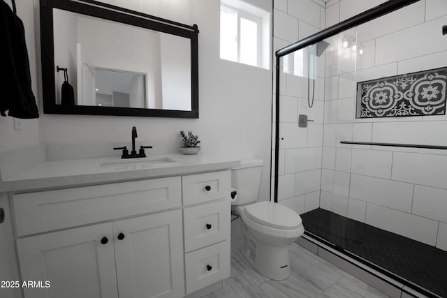 full bath featuring vanity, toilet, and tiled shower