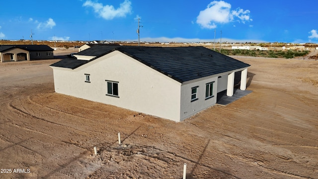 view of side of property with stucco siding