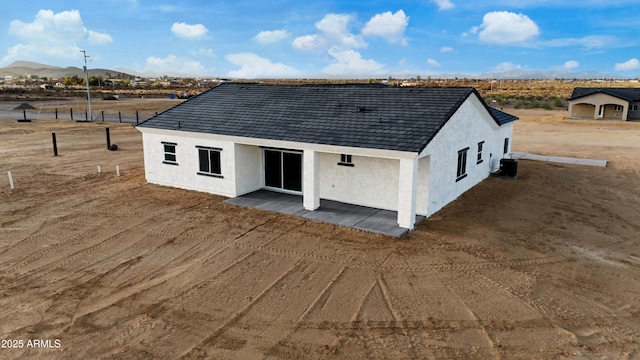 rear view of house featuring a patio, cooling unit, a mountain view, and stucco siding