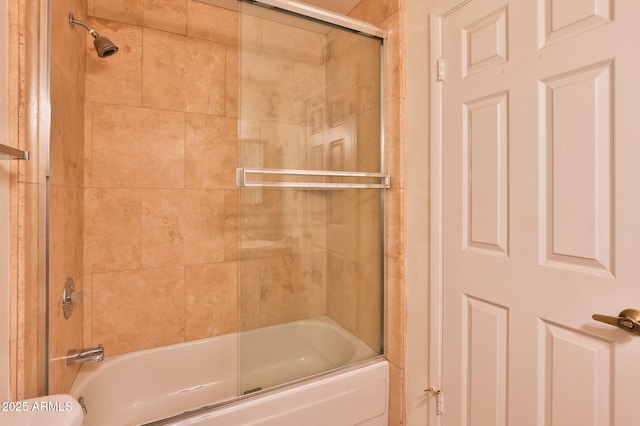 full bathroom with combined bath / shower with glass door and toilet
