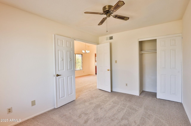 unfurnished bedroom featuring ceiling fan, visible vents, baseboards, a closet, and light carpet
