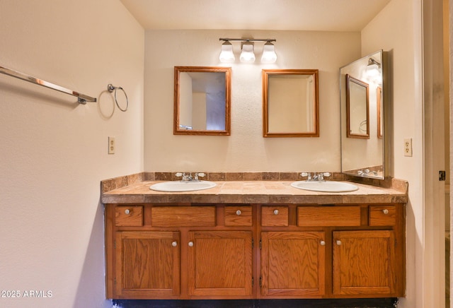 full bathroom with double vanity and a sink