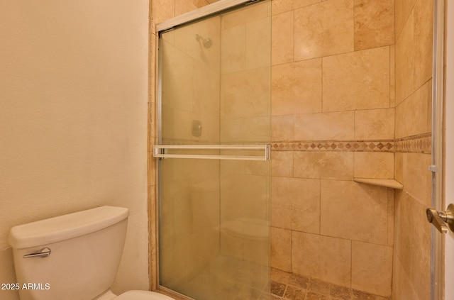 full bath with a shower stall and toilet
