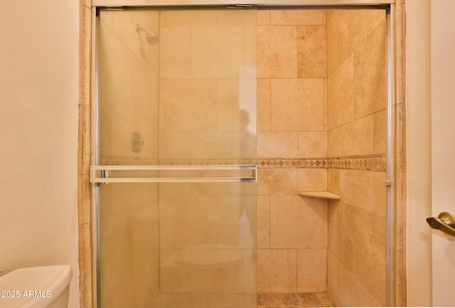 full bath with a stall shower and toilet