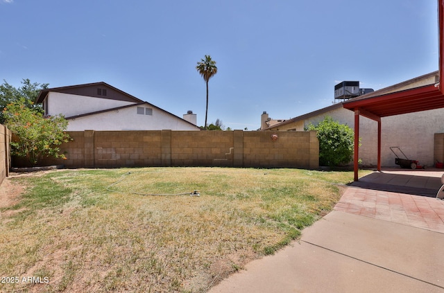 view of yard with a patio, central AC unit, and fence