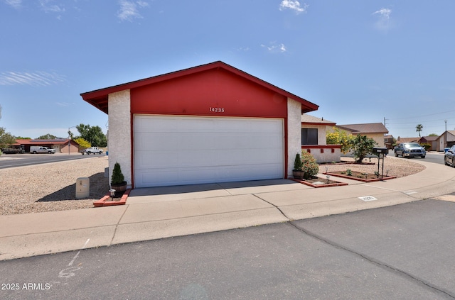 view of front of home with concrete driveway and stucco siding