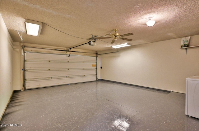 garage featuring baseboards, a garage door opener, washer / dryer, and a ceiling fan