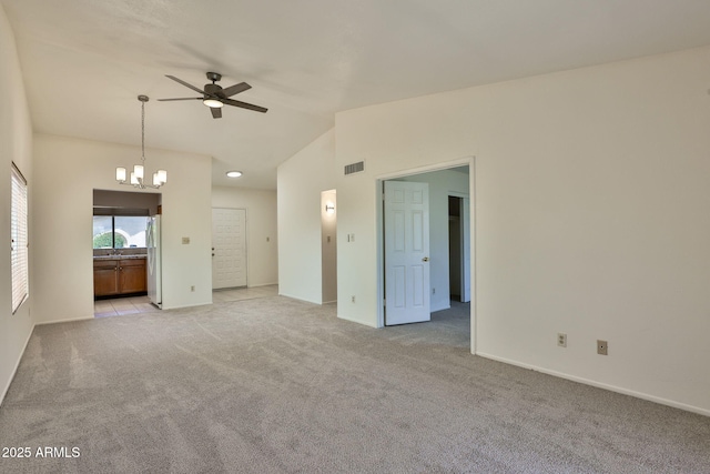 unfurnished living room featuring visible vents, baseboards, ceiling fan with notable chandelier, lofted ceiling, and light carpet