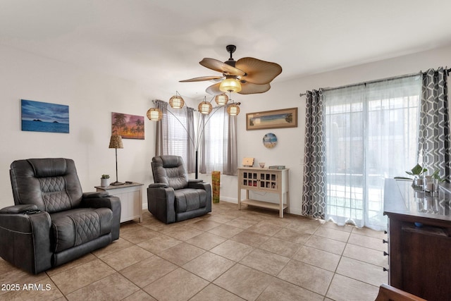 living area with light tile patterned floors, plenty of natural light, and ceiling fan