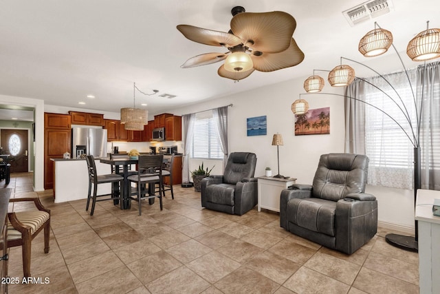 living room featuring light tile patterned floors and ceiling fan