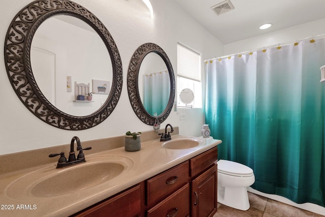 bathroom with vanity, tile patterned floors, and toilet