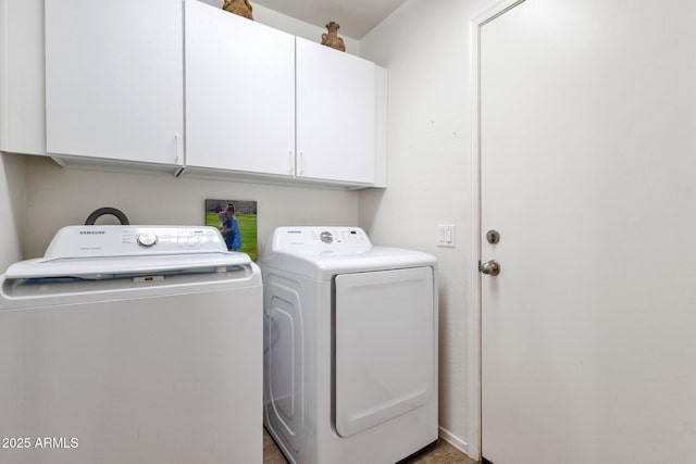 laundry room with cabinets and washing machine and clothes dryer