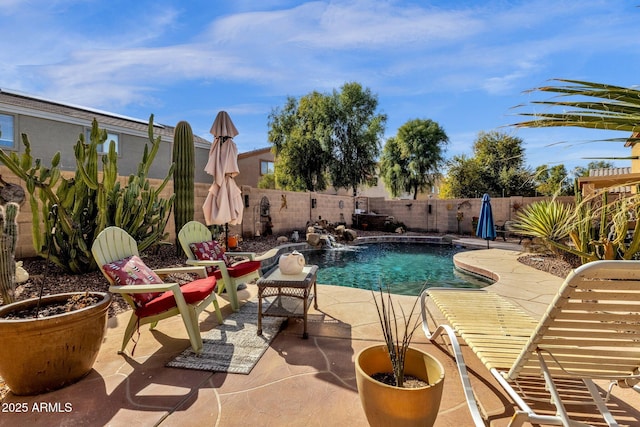 view of swimming pool with pool water feature and a patio area