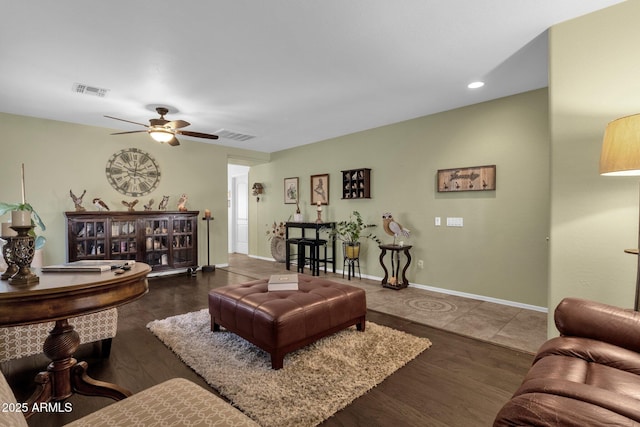 living room with dark wood-type flooring and ceiling fan