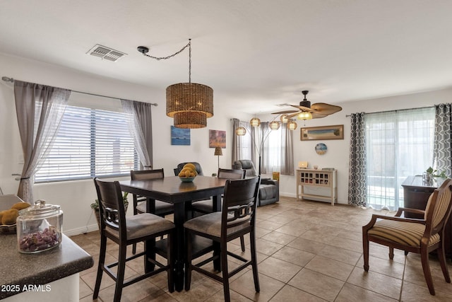 dining room with tile patterned flooring, a wealth of natural light, and ceiling fan