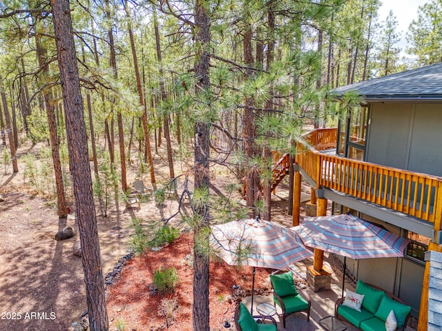 wooden terrace with a view of trees