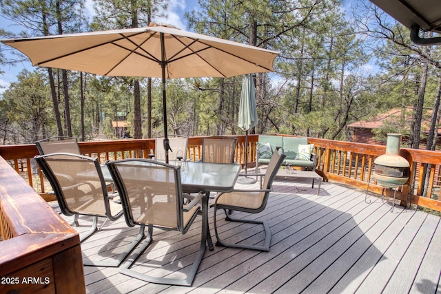 wooden deck featuring outdoor dining area