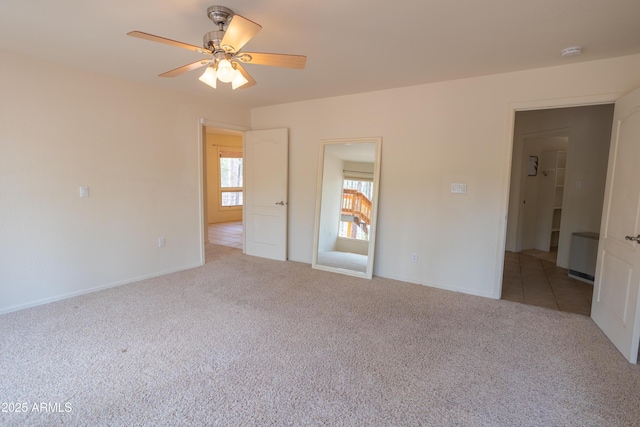 unfurnished bedroom featuring ceiling fan, carpet flooring, and baseboards