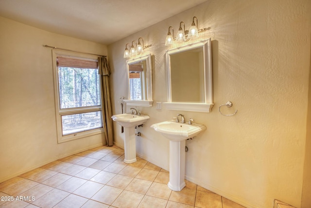 bathroom with tile patterned floors and baseboards