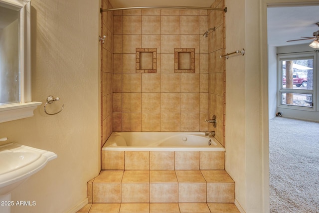 bathroom with tiled shower / bath and a ceiling fan