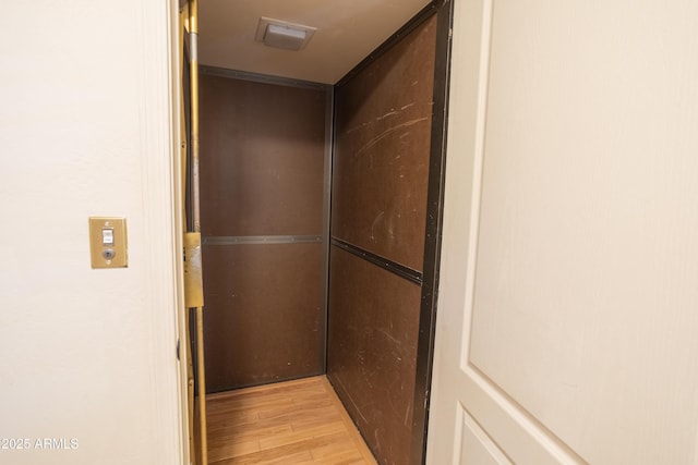 details featuring wood finished floors and elevator