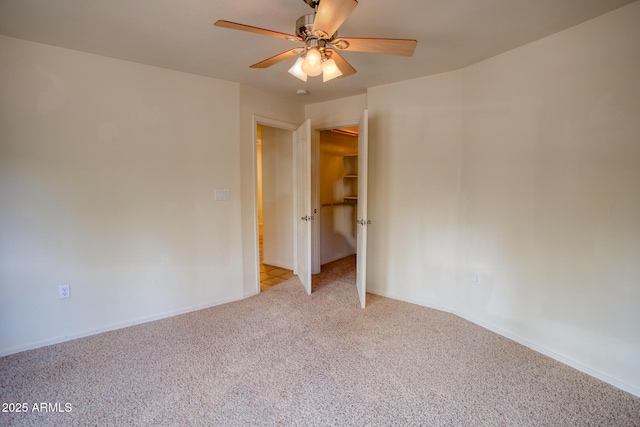 empty room with light carpet, baseboards, and a ceiling fan