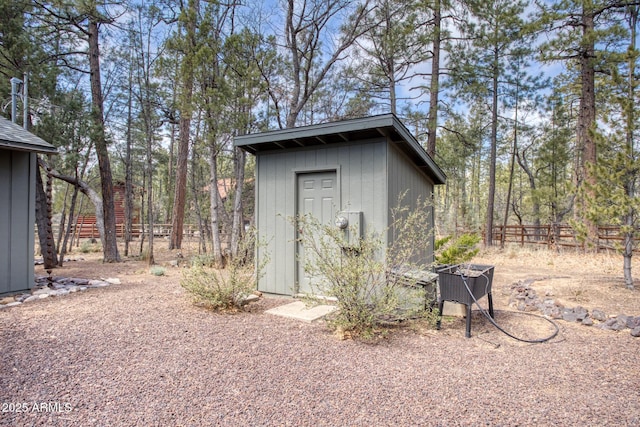 view of shed with fence
