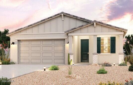 24553 W Hopi St, Buckeye, AZ 85326 - view of front of home with a garage, board and batten siding, stucco siding, and concrete driveway