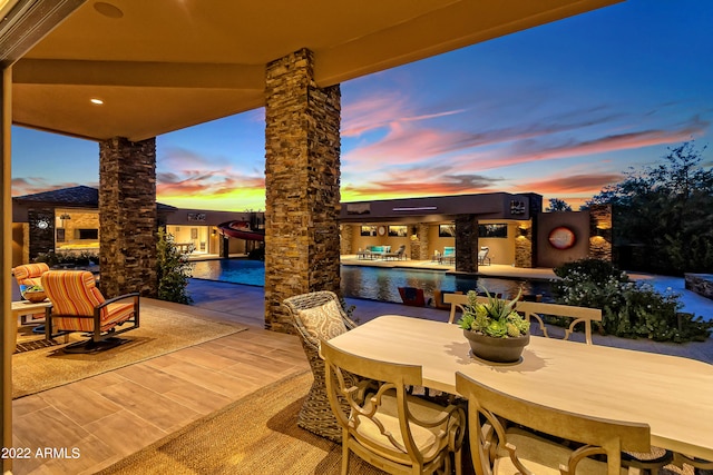 view of patio terrace at dusk