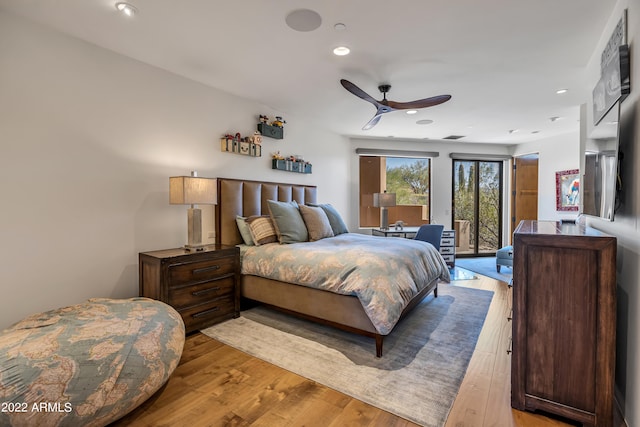 bedroom featuring access to exterior, ceiling fan, and light hardwood / wood-style flooring