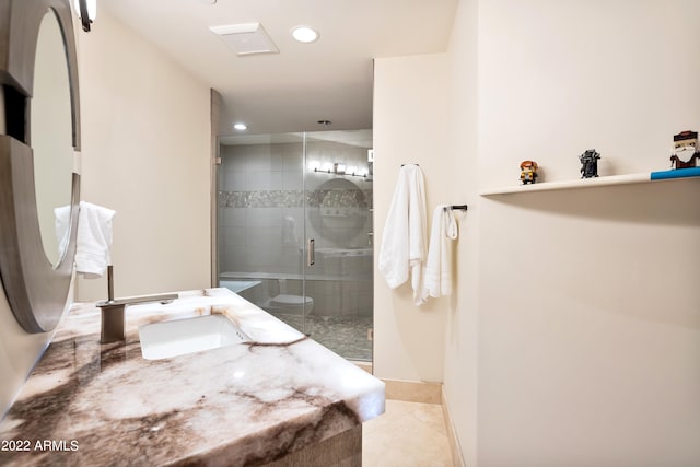 bathroom featuring tile flooring, vanity, and a shower with shower door