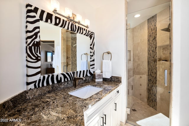 bathroom featuring walk in shower and oversized vanity