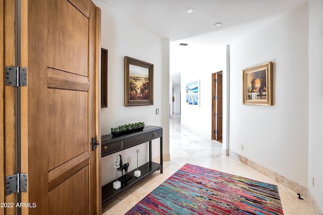 hall featuring light tile floors