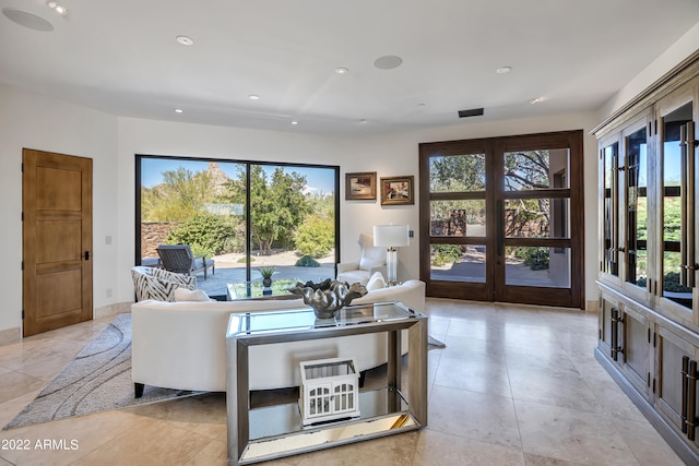 living room with plenty of natural light and light tile floors