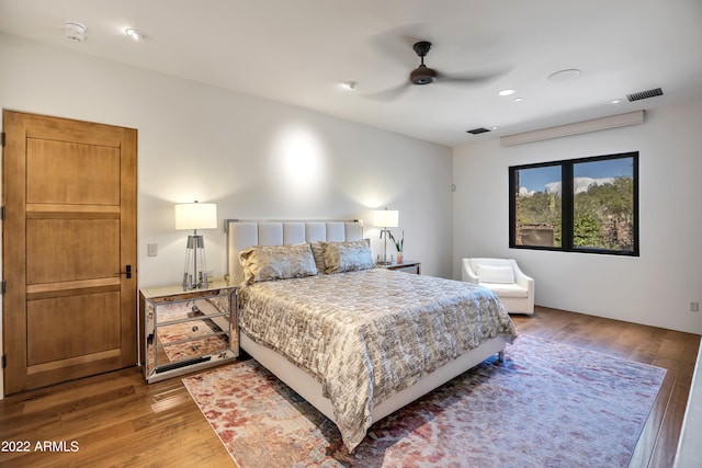 bedroom with ceiling fan and hardwood / wood-style flooring