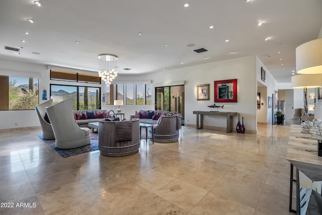 tiled living room featuring a notable chandelier