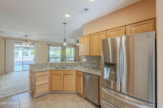 kitchen featuring kitchen peninsula, backsplash, stainless steel appliances, sink, and light brown cabinets