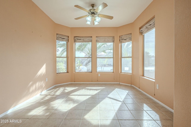 tiled empty room with ceiling fan