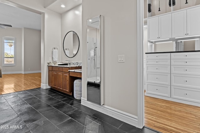 bathroom featuring vanity, an enclosed shower, and wood-type flooring